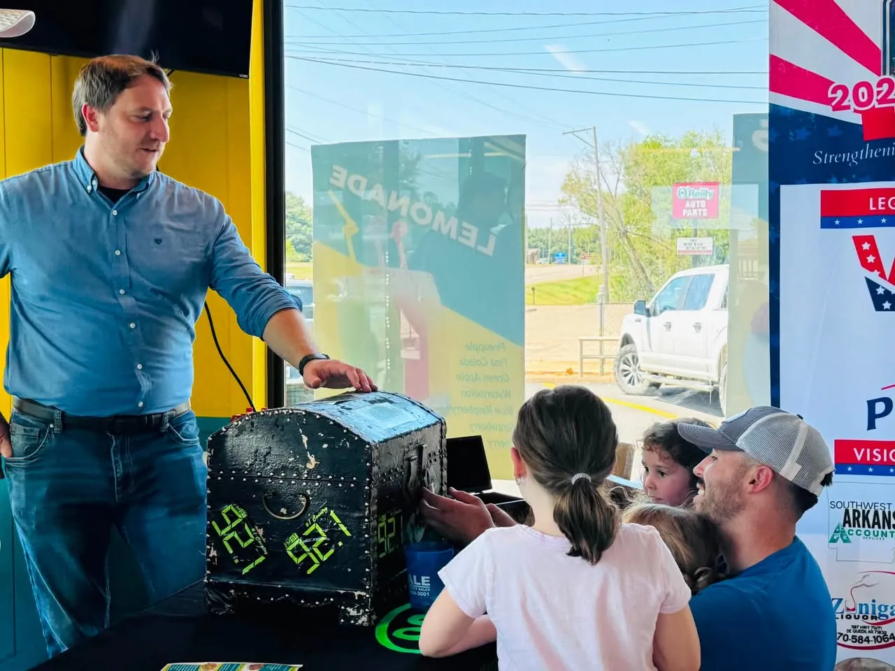A De Queen family at the KDQN 92.1 prize chest during the Sharks opening celebration