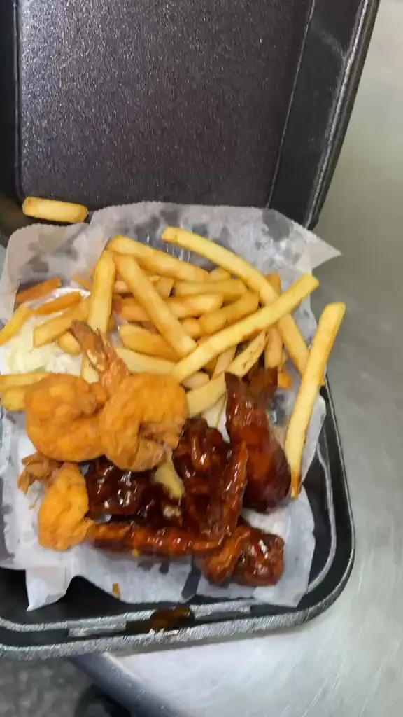 A two-item combo of glazed whole wings and breaded shrimp with fries